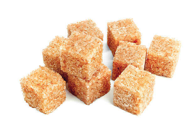 istock Lump brown cane sugar cubes isolated on white background 530313051