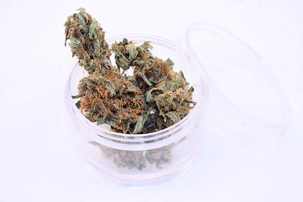 istock Cannabis buds in a transparent container on a white background 530314575