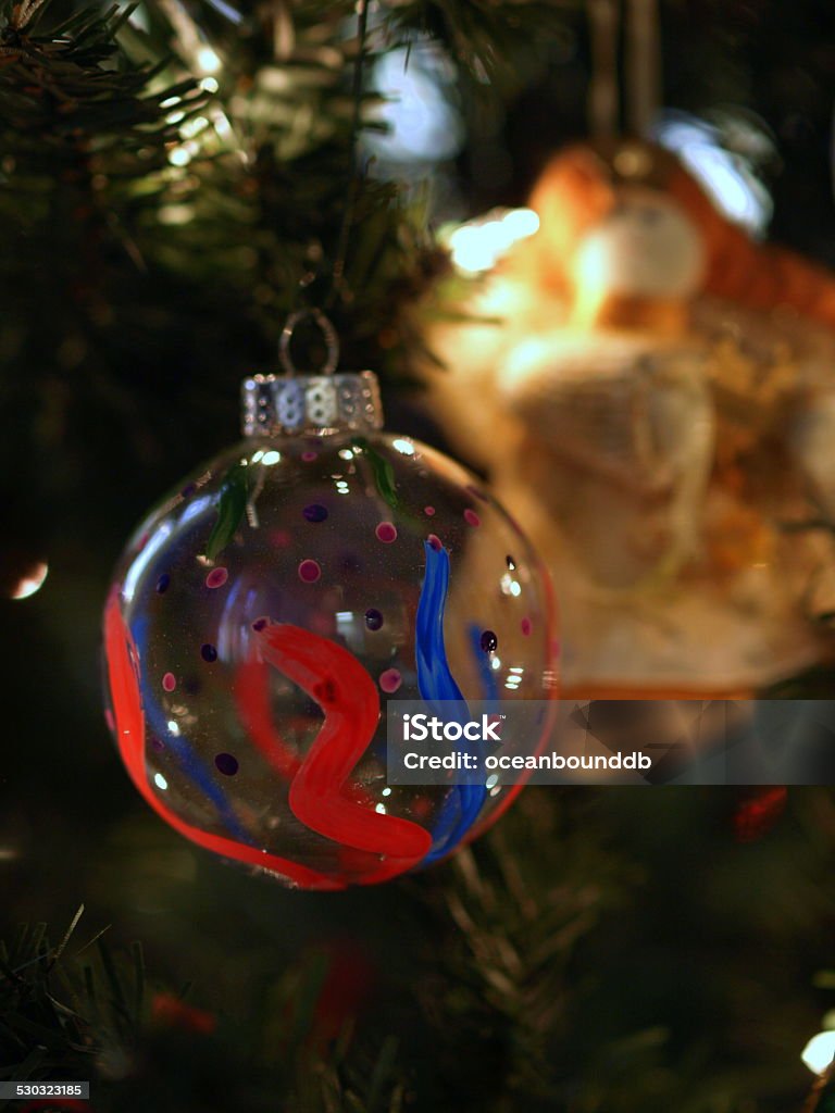 two Christmas Ornaments hang on tree Two handmade Christmas ornaments hang on a Christmas tree. Art And Craft Stock Photo