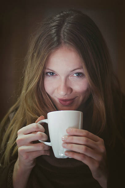 istock Girl drinking morning coffee with lovely smile 530323209