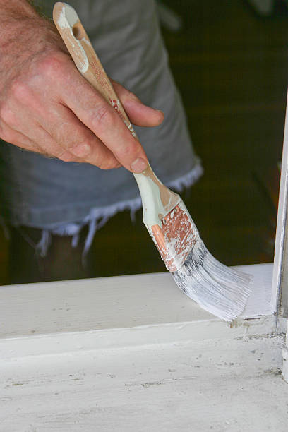 Man Painting a Window Frame stock photo