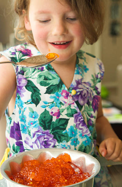 istock Young child having fun eating jelly from a spoon 530324077