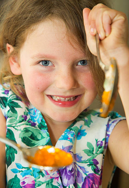 istock Young child having fun eating jelly from a spoon 530324087