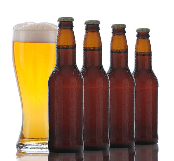istock Four Brown Beer Bottles and Full Glass 530324887