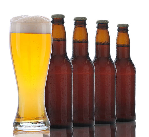 istock Four Brown Beer Bottles and Full Glass 530324889