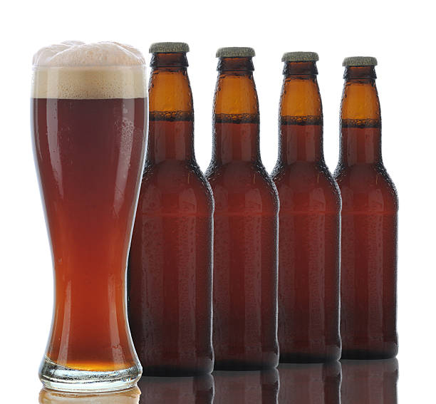 istock Four Brown Beer Bottles and Full Glass 530324915