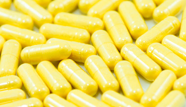 istock Yellow drug capsules macro 530325071