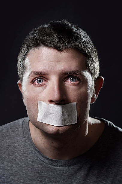 istock attractive young man  mouth sealed on adhesive  tape 530333565