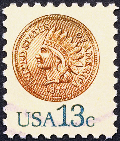 Indian head penny on postage stamp