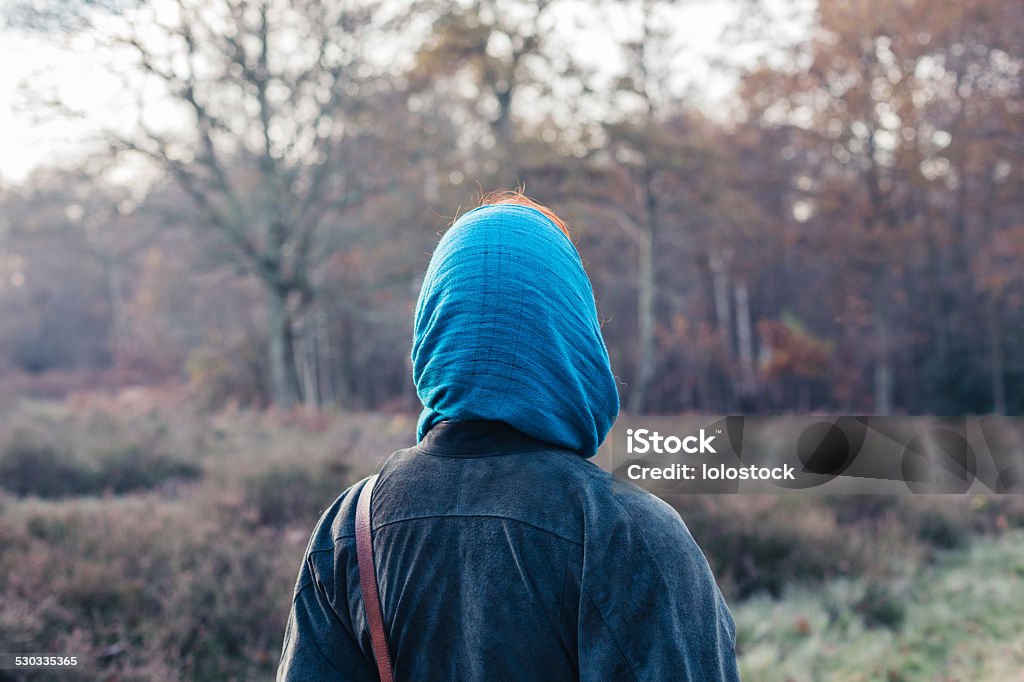 Woman wearing headscarf in forest A woman wearing a headscarf is standing in the forest Adult Stock Photo