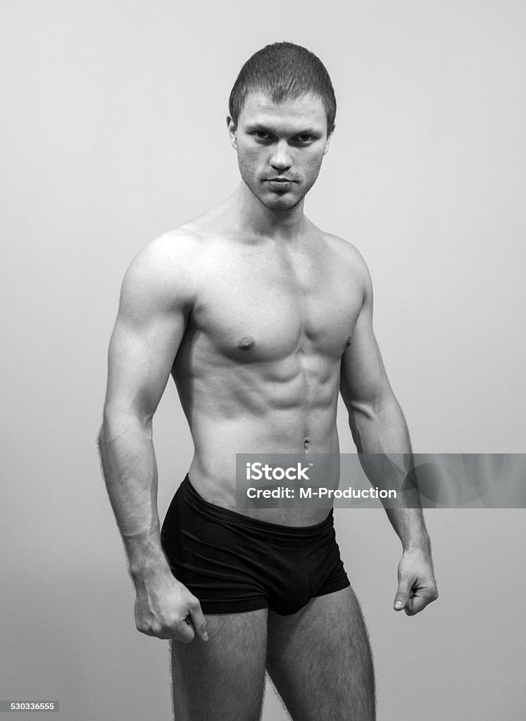 Muscular male model posing. Black and white. Abdominal Muscle Stock Photo