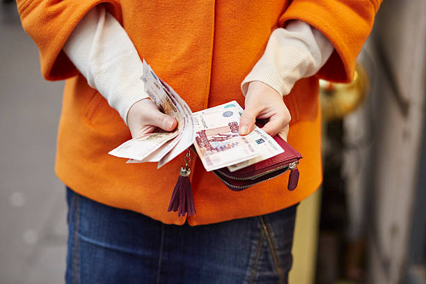 istock Woman hands holding purse with Russian roubles 530336943