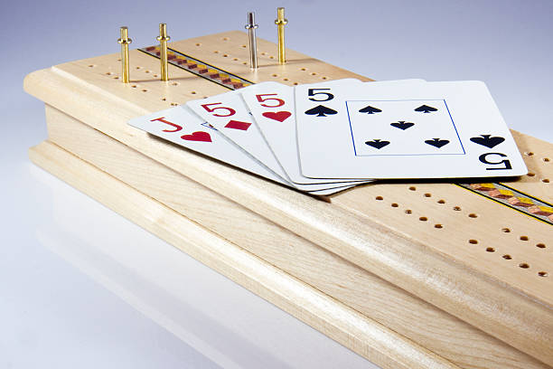 Cribbage Board and hand of cards stock photo