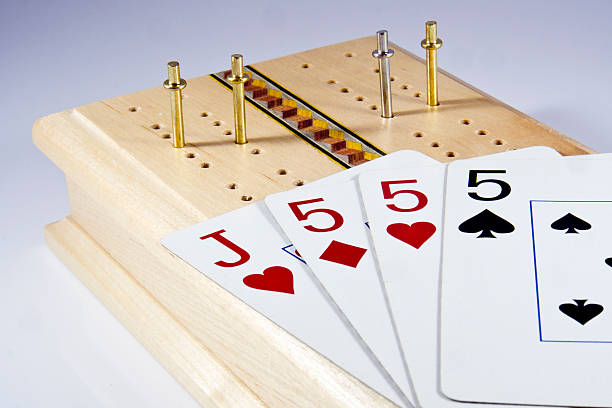 Cribbage Board and hand of cards stock photo