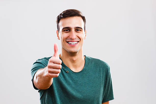 Thumbs up for braces stock photo