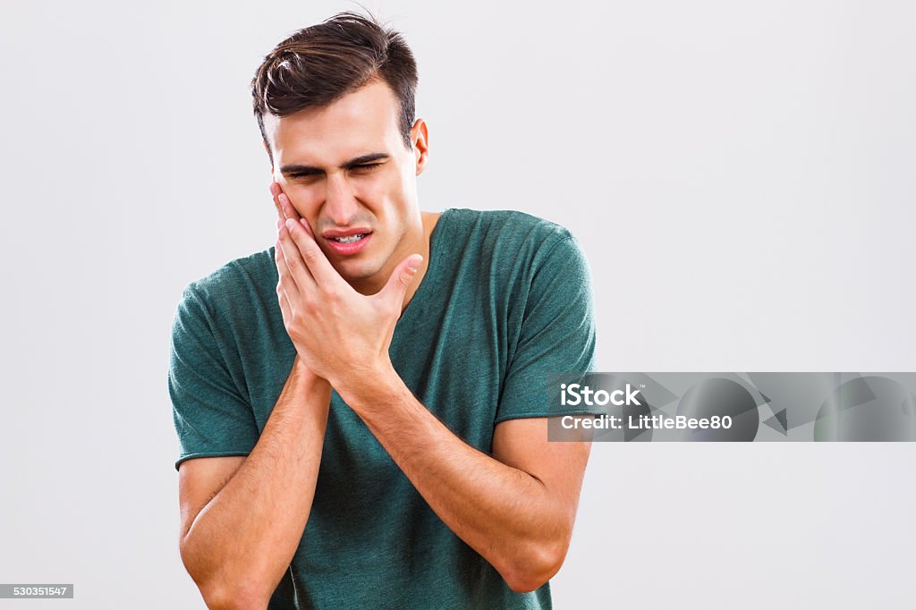 Toothache Young man is having toothache. Pain Stock Photo
