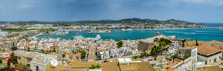 Panorama of Ibiza town, Spain with buildings & yachts in the background