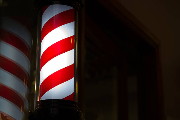 istock Illuminated Barbershop Pole Against Black (Close-Up) 530353661