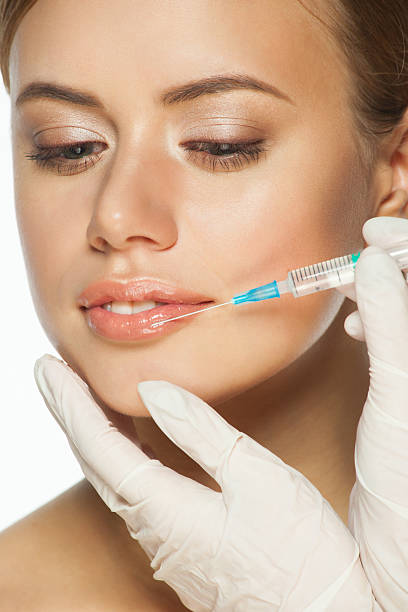 istock Botox injection to the lips 530354551