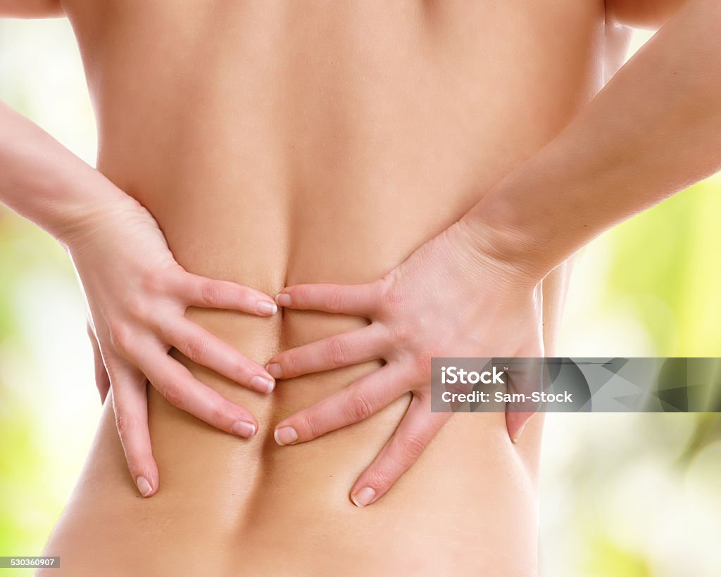 young woman has strong back pain Adult Stock Photo