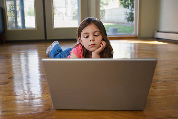 istock Girl Using Laptop On Hardwood Floor 530361647