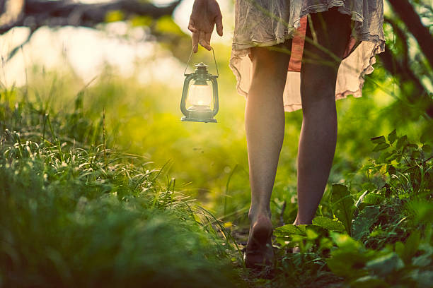 Woman with lantern in the forest Woman with lantern walking in the forest Barefoot stock pictures, royalty-free photos & images