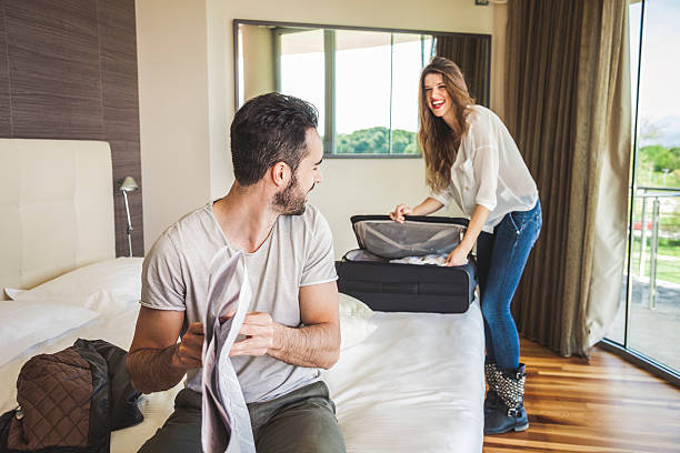 Couple in hotel room getting dressed