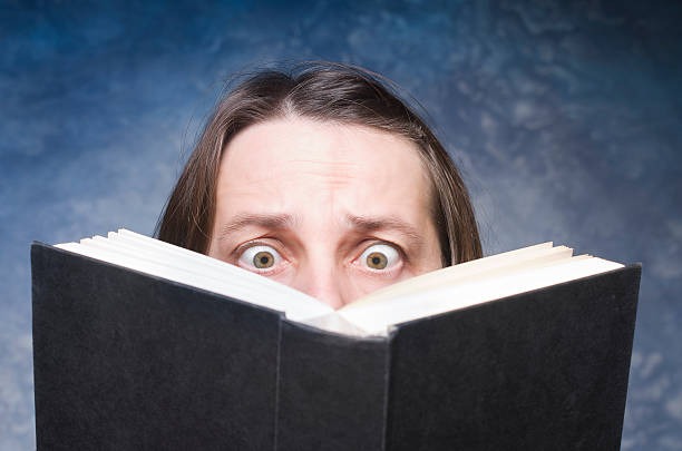 Mature woman being focused and hooked by book.