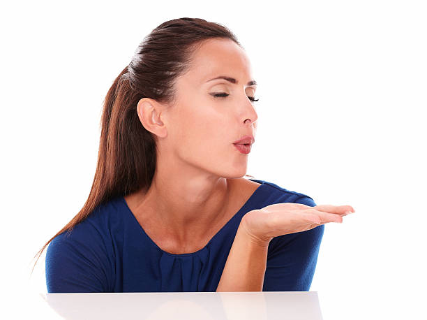 istock Beautiful lady with closed eyes blowing a wish 530363713