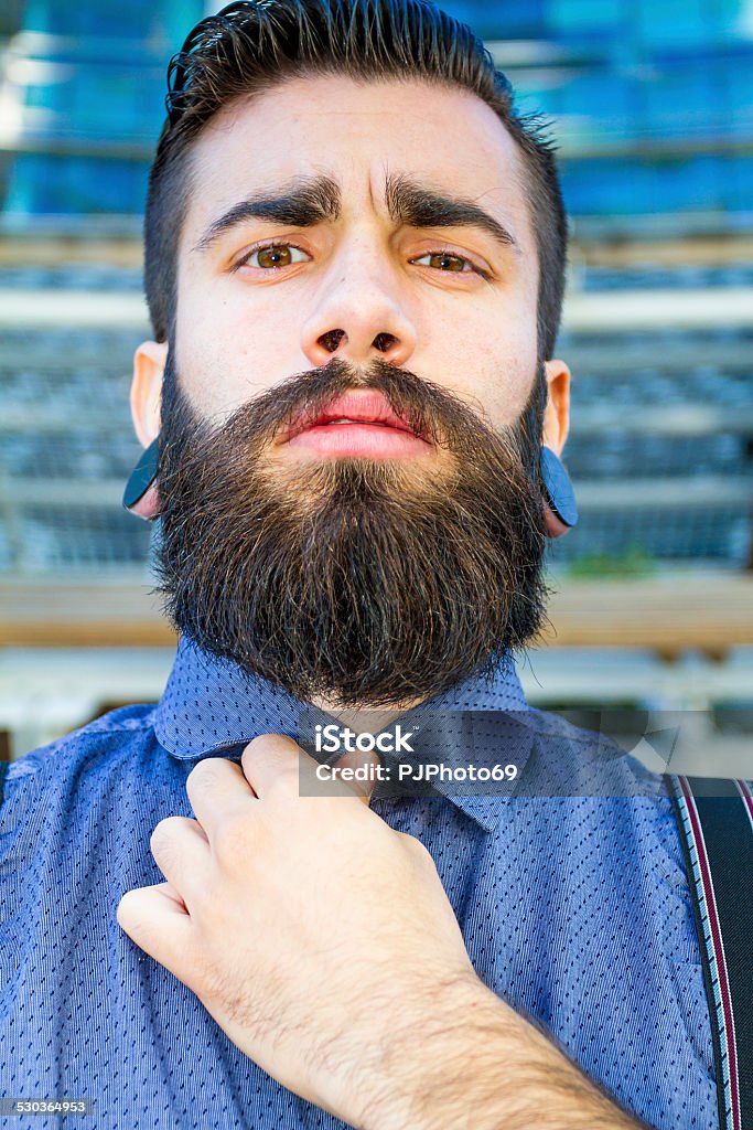 Portrait of young man (Hipster style) Portrait of Young man (hispter style) with big earring and full beard Artist's Model Stock Photo
