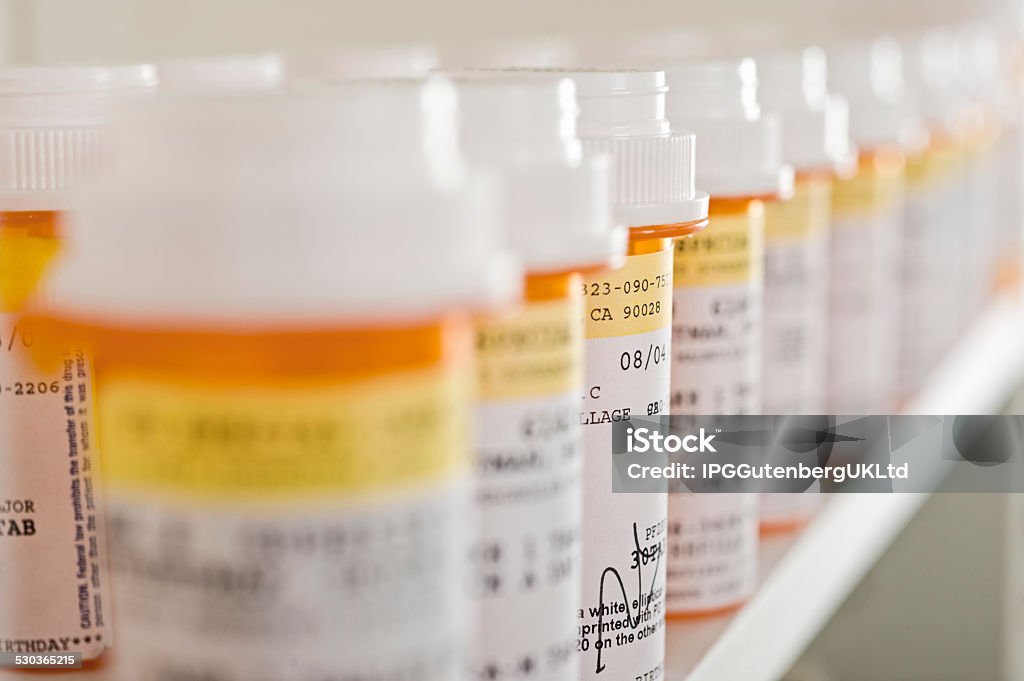 Medicine Bottles Arranged In Shelf Bottles of pills arranged in shelf at a drugstore Medicine Stock Photo