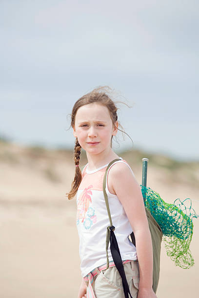 istock girl standing on beach 530365289