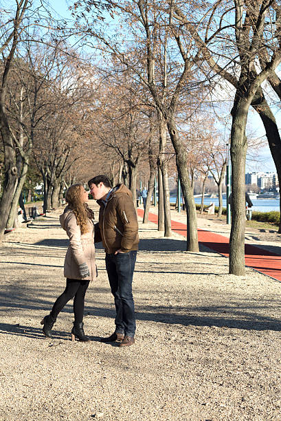 Young couple kissing in the park Young couple kissing in the park margitsziget stock pictures, royalty-free photos & images