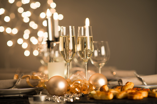 new years eve party table with champagne flute ribon and golden glitter