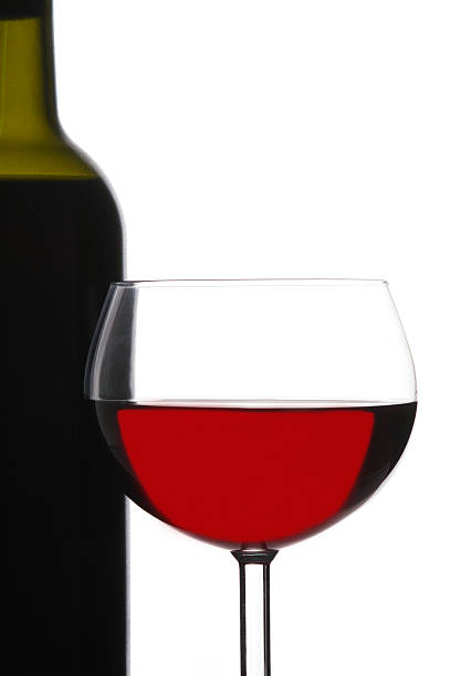 istock Red Wine Glass in Front of Bottle 530367715