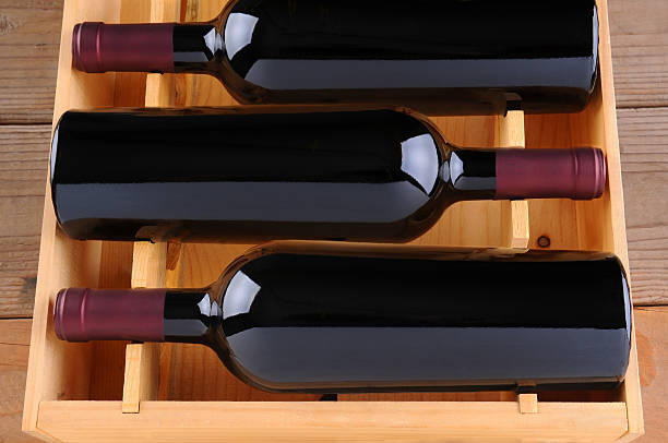 istock Three Red Wine Bottles in Wood Case 530367969