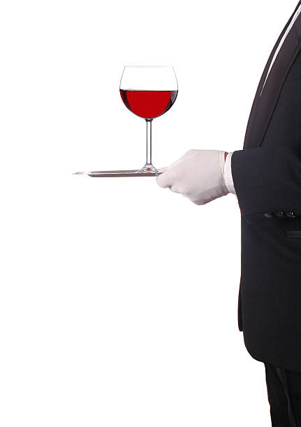 istock Man in Tuxedo with Red Wine on Tray 530368473