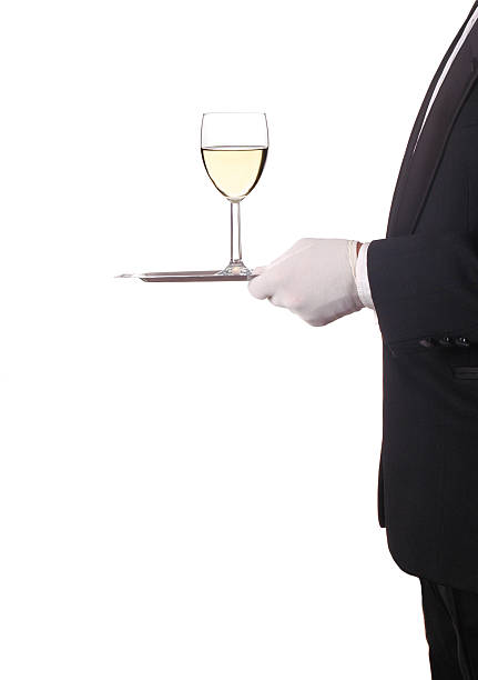 istock Man in Tuxedo with Red Wine on Tray 530368475