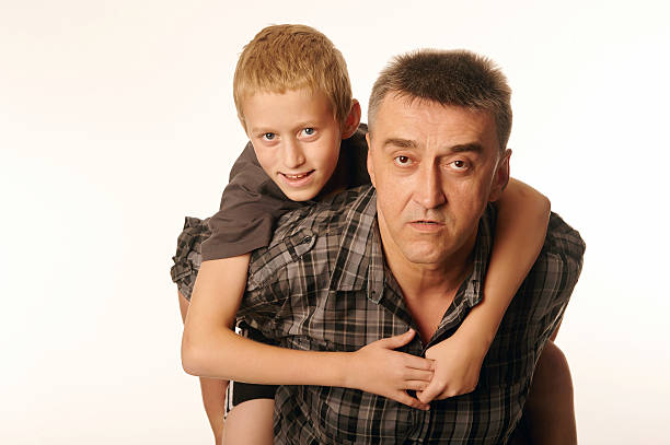 istock Ten year old son cheerfully embraced his father 530379923