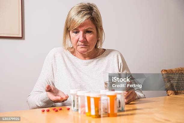 Struggling With An Addiction To Painkillers Stock Photo - Download Image Now - Confusion, Mature Women, Medicine