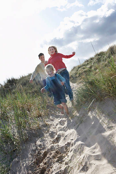 istock Cheerful Family Running Through Sand Dunes 530380743