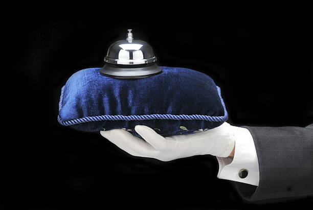 Bulter with Call Bell Butlers outstretched hand and arm with call bell on velvet pillow formal glove stock pictures, royalty-free photos & images