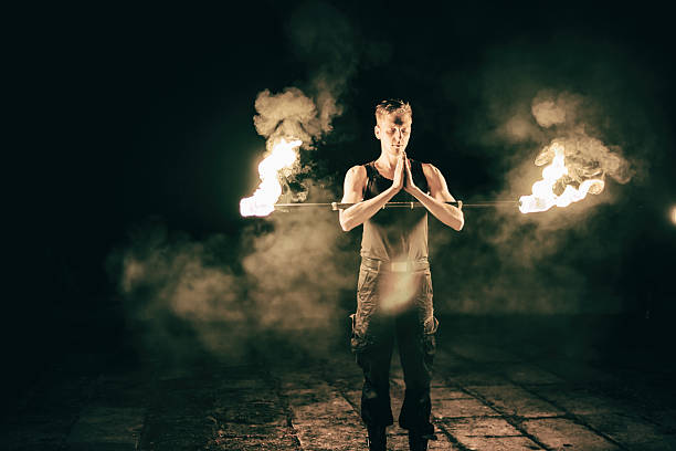 istock active European guy carries out tricks for fire show night 530381385