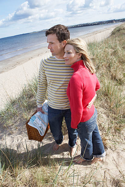 istock Couple Embracing On Beach 530382937