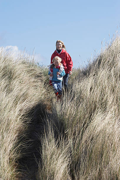 istock Daughter With Mother Walking Through Long Glass 530382957