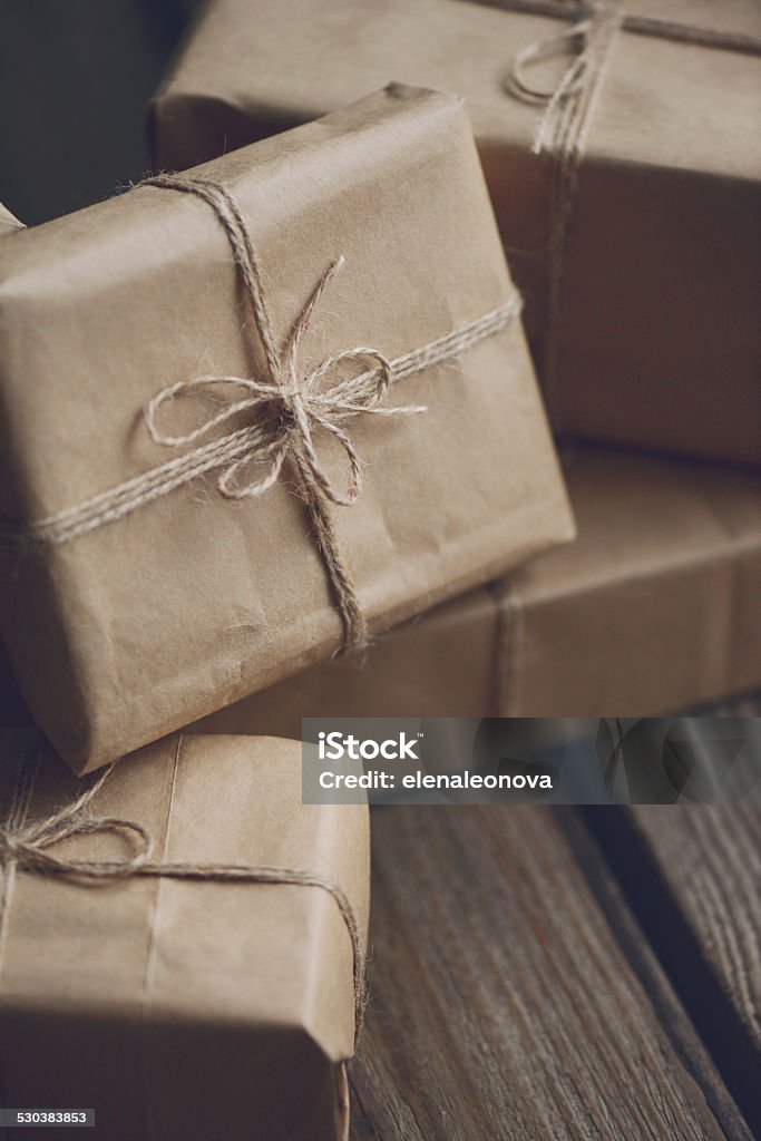gift boxes gift boxes wrapped in brown paper on old wooden background Art And Craft Stock Photo
