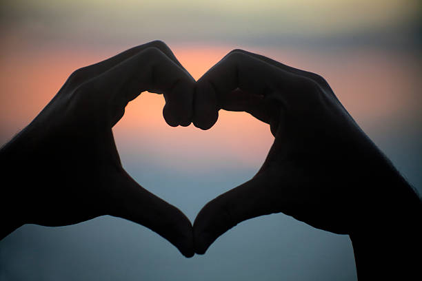 istock Heart shape in front of seascape sunset. 530384521