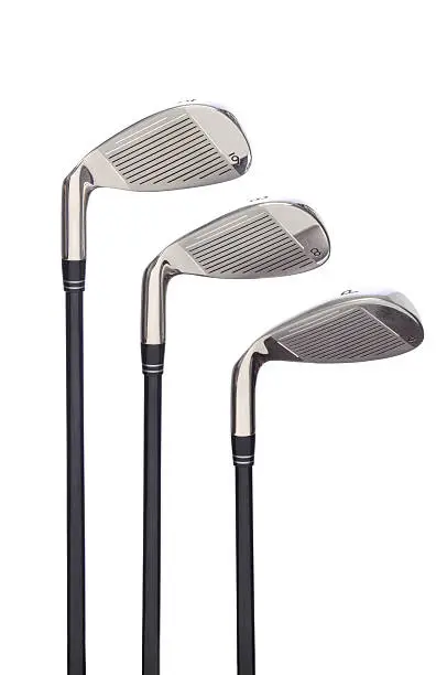 Set of three Golf Irons  on a white background with reflection.