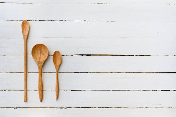 istock wooden spoon on white wooden table 530393189