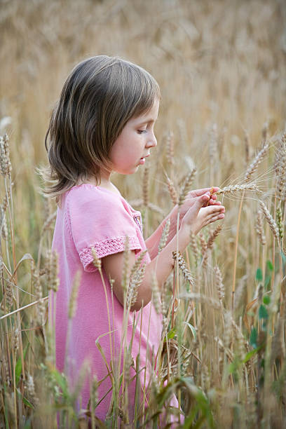 istock Little Girl Standing In Field 530393253